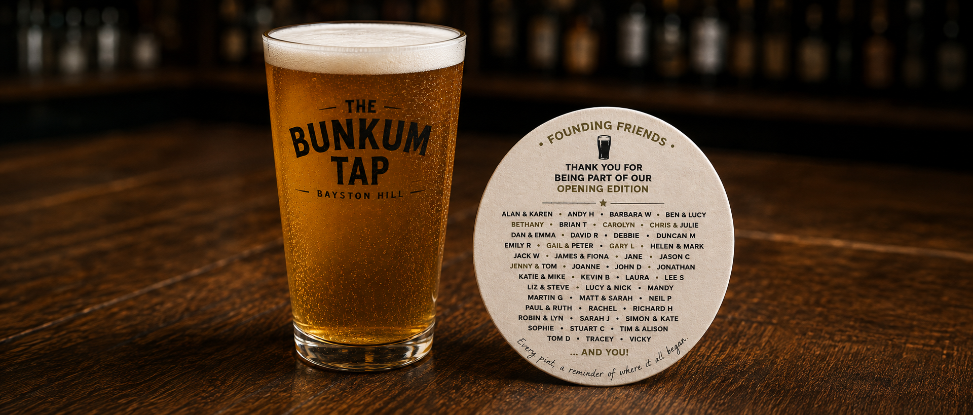 A pint of The Bunkum Tap beer beside a Founding Friends opening-edition beermat on the bar